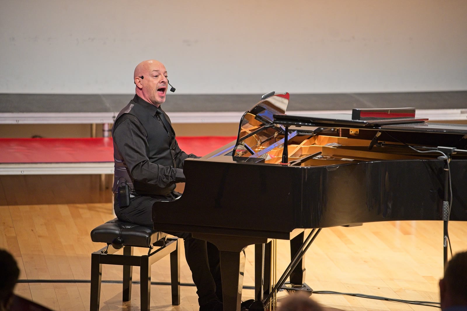Russell Scott working at the piano during a singing workshop